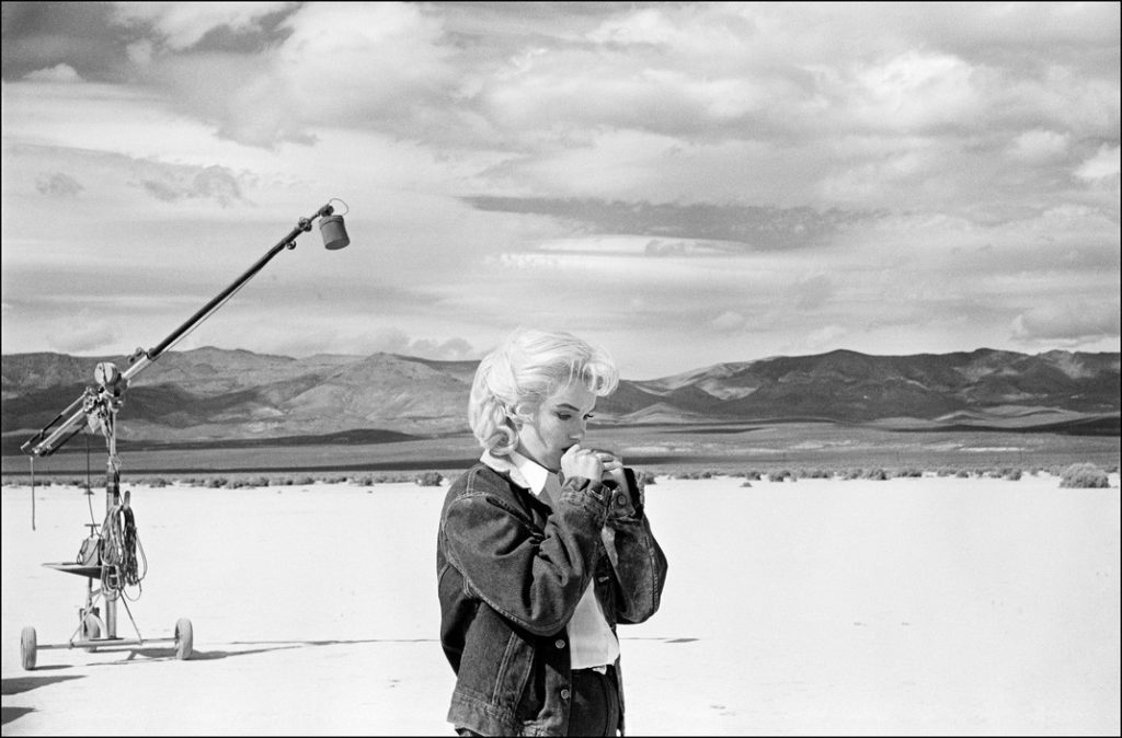 UNITED STATES. Nevada. American actress Marilyn MONROE in the Nevada desert reviews her lines for a tough scene she is about to perform with Clarke GABLE in John HUSTON's film 'The Misfits'. 1960. EVE ARNOLD